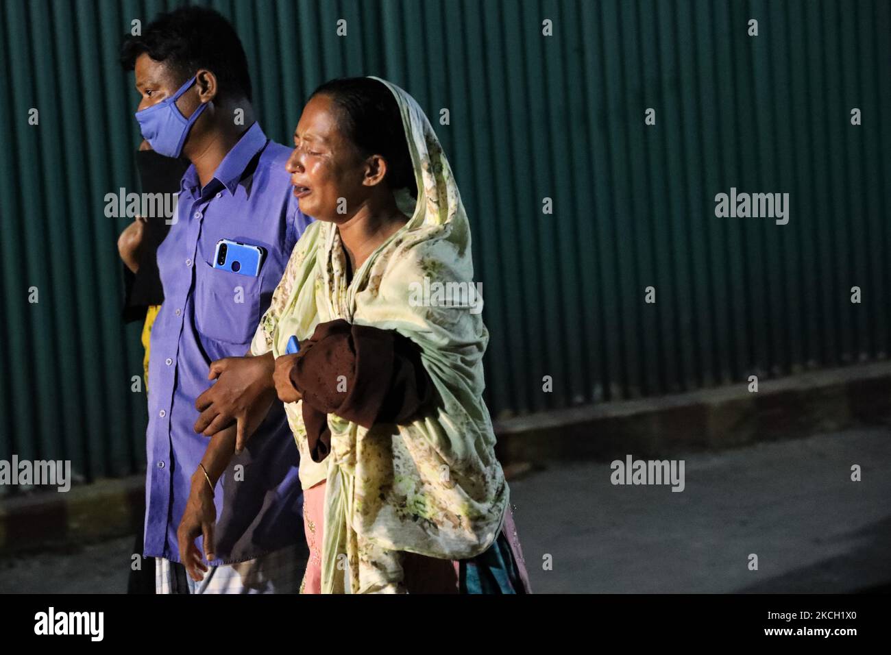 Nazma Akhter mourns for her missing son near a fire scene of a juice