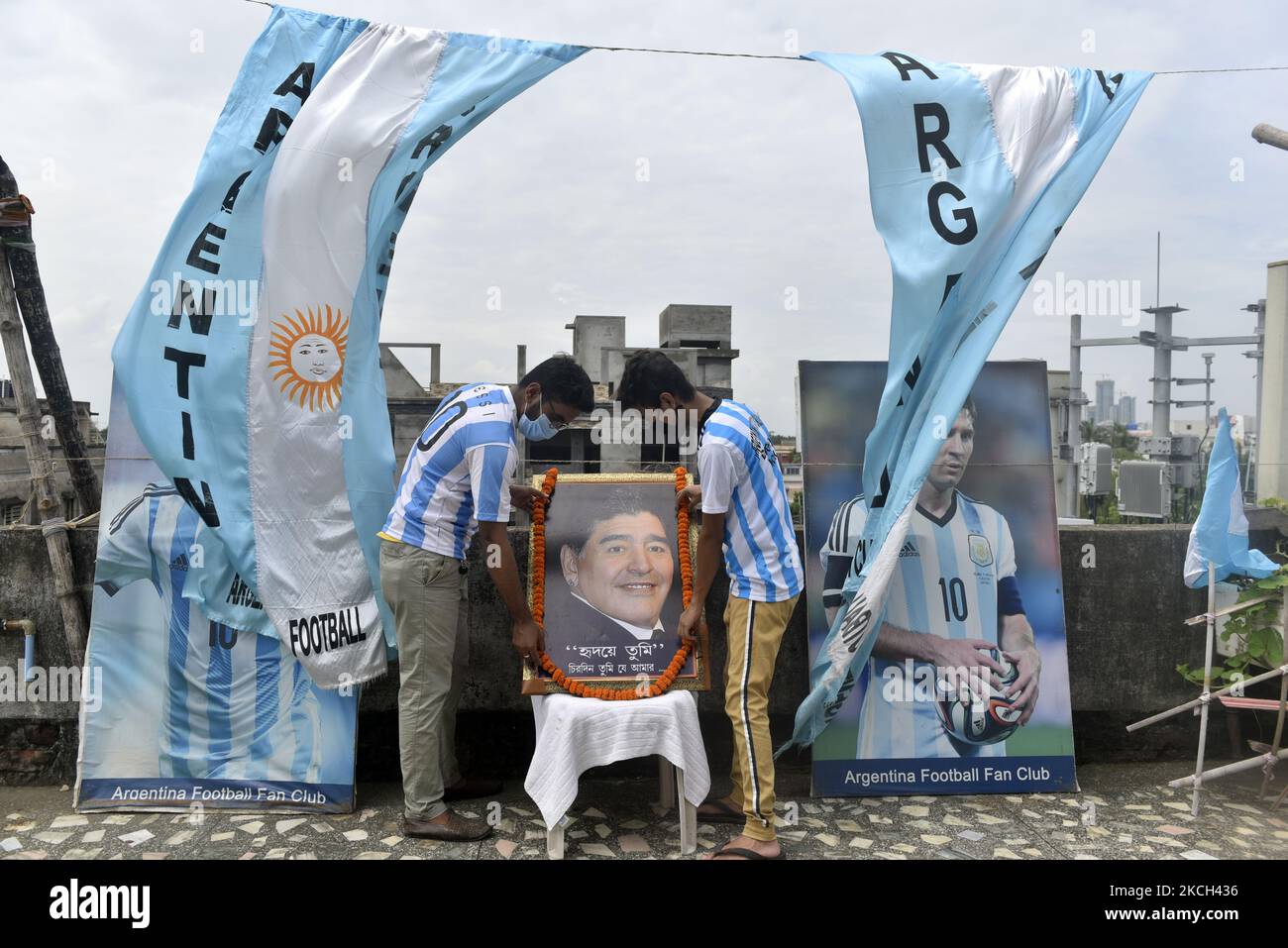 Members of an Argentina's national football team fan club places a portrait of late Argentine football legend Diego Maradona in a rooftop ahead of the Copa America final match between Argentina and Brazil, Kolkata, India, 10 July, 2021. (Photo by Indranil Aditya/NurPhoto) Stock Photo