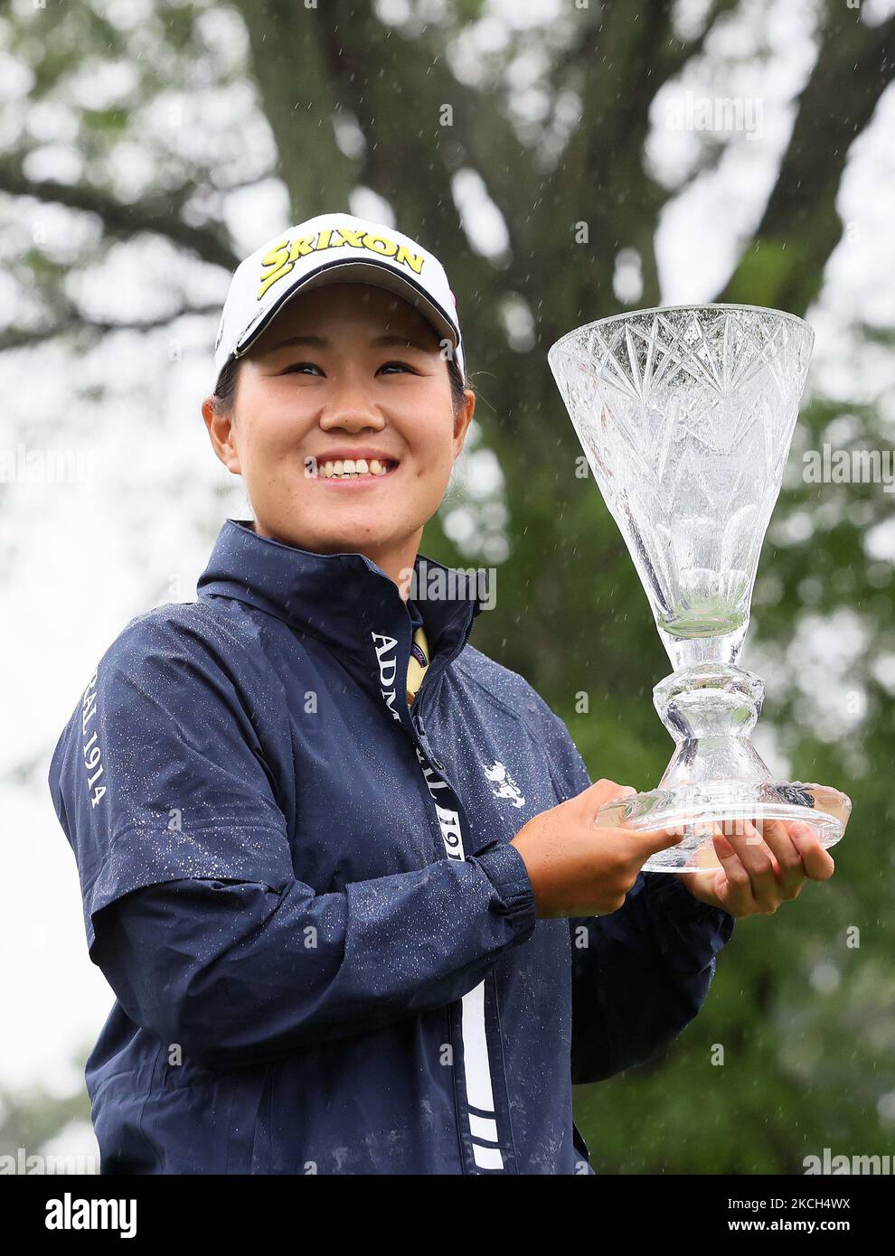Nasa hataoka of ibaraki japan holds the winner s trophy in the rain