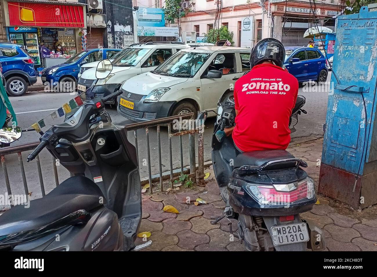 A ZOMATO food delivery partner waits to receive the order of food , in