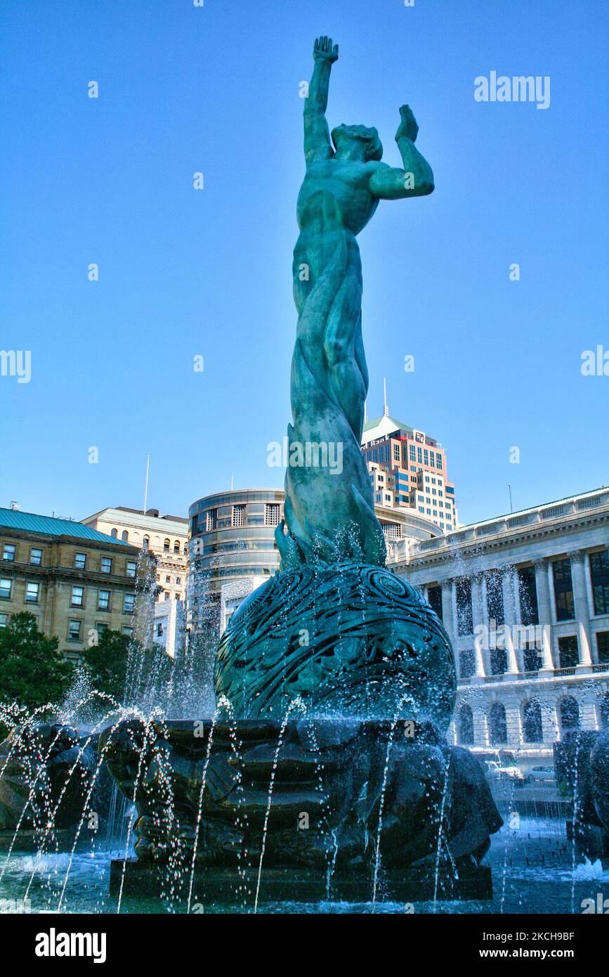 Located in Cleveland's Veterans' Memorial Plaza, stands the 'Fountain of Eternal Life' in Cleveland, Ohio, USA, on September 02, 2007. The fountain is also known as the 'War Memorial Fountain' or 'Peace Arising from the Flames of War' and consists of a statue and fountain that serves as Cleveland’s memorial to those citizens who served and died in World War II and the Korean War. It was designed by Cleveland Institute of Art graduate Marshall Fredericks and dedicated on May 30, 1964. The centerpiece is a 35-foot (10.7 m) bronze figure representing man escaping from the flames of war and reachi Stock Photo