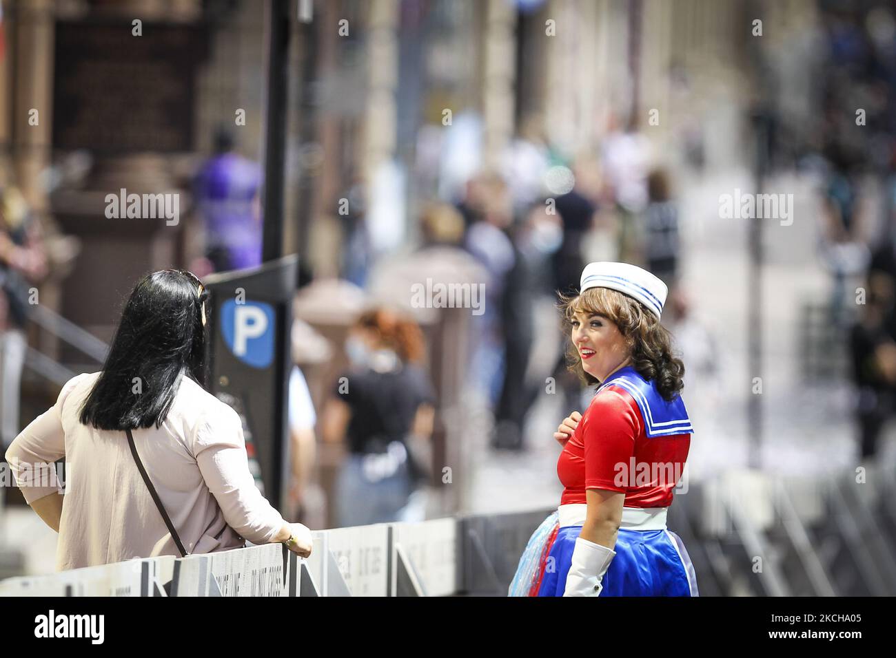 Crew and cast member are seen on set as filming for the