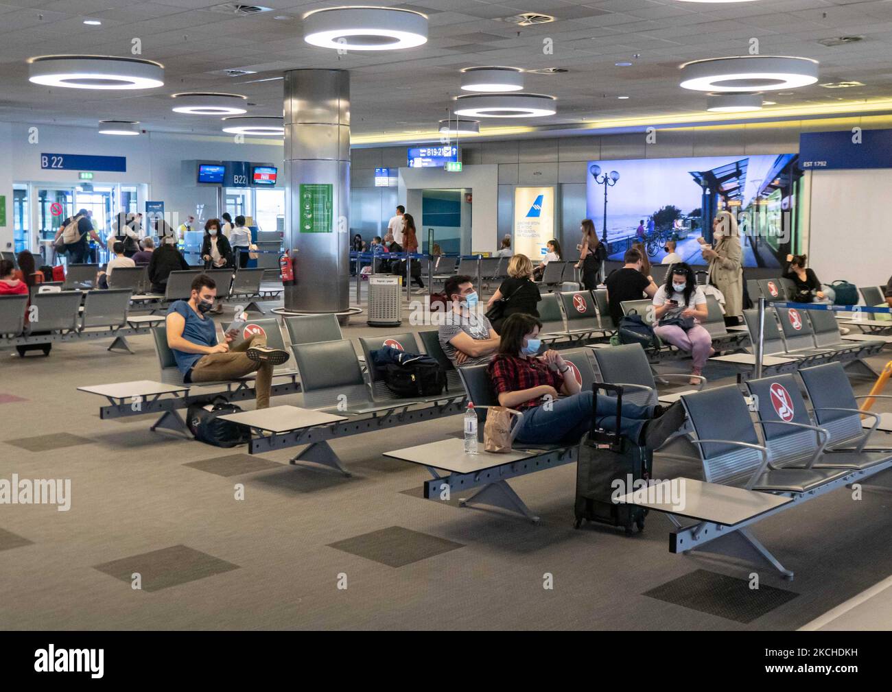 People in the waiting area in front of the gates in Athens Airport