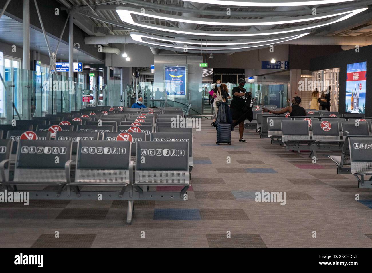 People in the waiting area in front of the gates in Athens Airport