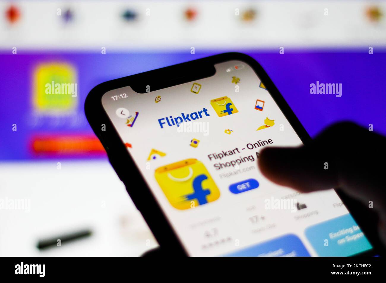 Flipkart logo on the App Store displayed on a phone screen and Flipkart website displayed in the background are seen in this illustration photo taken in Krakow, Poland on July 20, 2021. (Photo by Jakub Porzycki/NurPhoto) Stock Photo