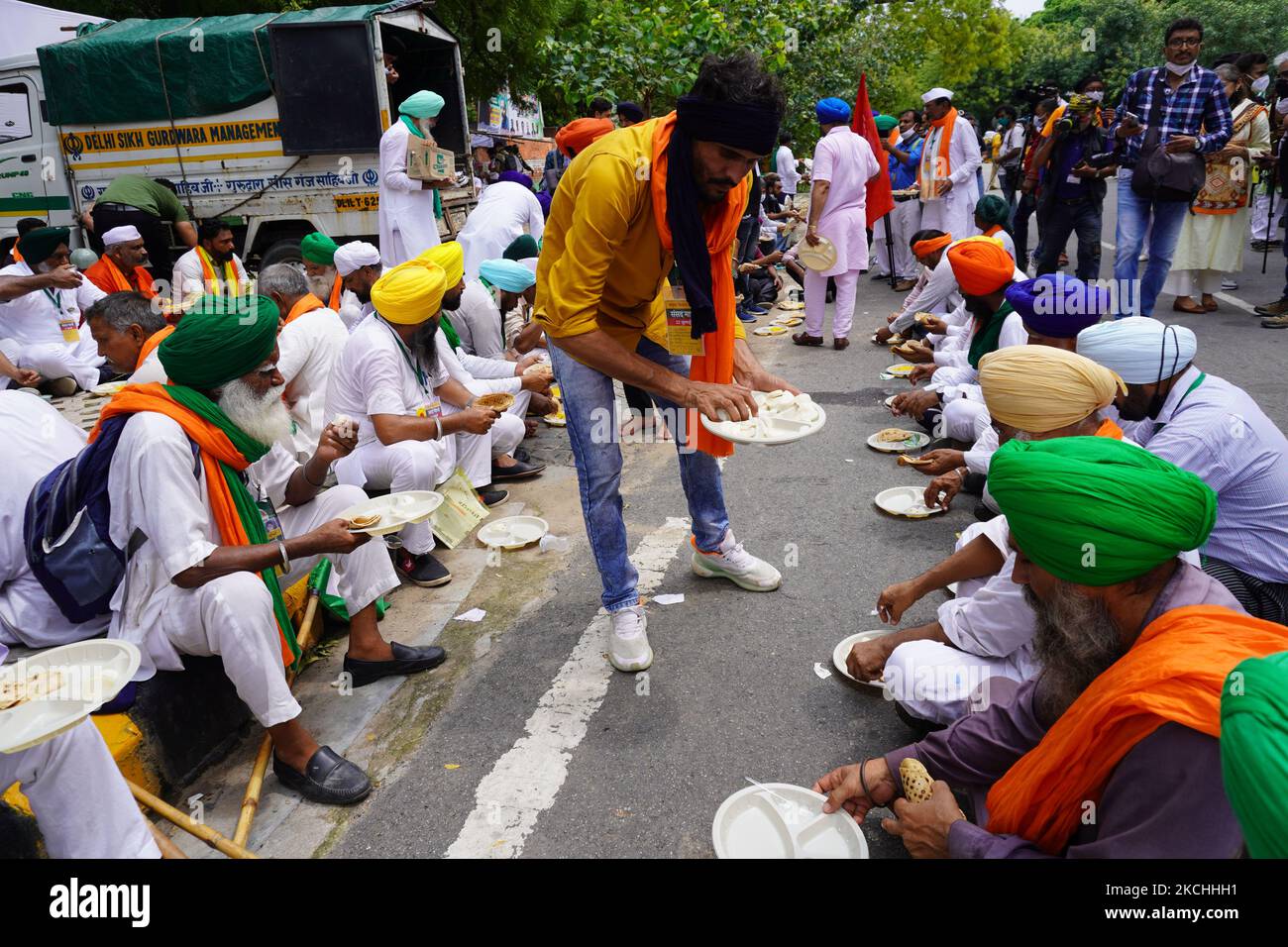 Indian farmers have lunch during a mock parliament as they protest against three agricultural reforms, in New Delhi, India on July 22, 2021. A group of 200 farmers began a protest near India's Parliament to protest against the three contentious farm laws as the Monsoon session of Parliament was underway. (Photo by Mayank Makhija/NurPhoto) Stock Photo