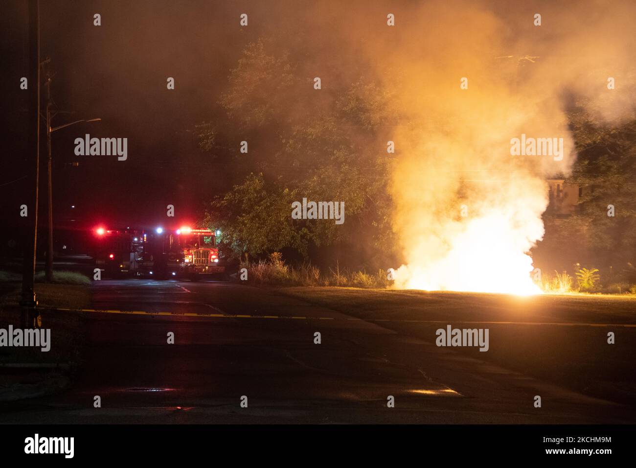 Detroit Fire Fighters control a downed power line caused by extreme winds on July 24, 2021, from a severe thunderstorm that rolled through the city and also caused severe flooding of roads and homes. (Photo by Adam J. Dewey/NurPhoto) Stock Photo