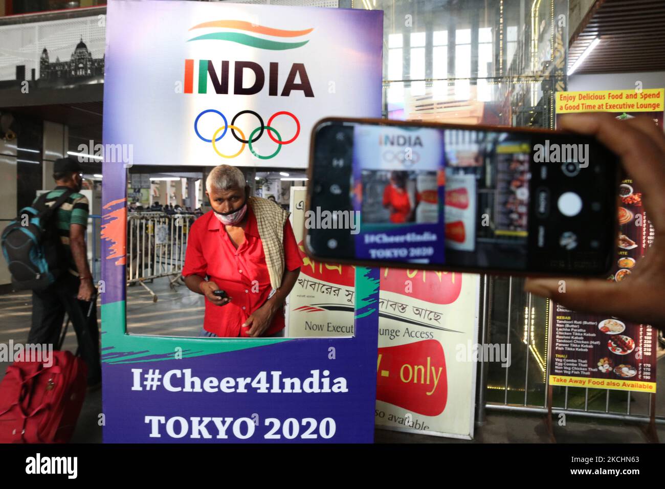 Railway porters take selfie for a picture with an Olympic themed kiosk installed at a railway station to show support to the Indian athletes participating in the Tokyo Olympics 2020 in Eastern India city Kolkata on July 24, 2021. (Photo by Debajyoti Chakraborty/NurPhoto) Stock Photo