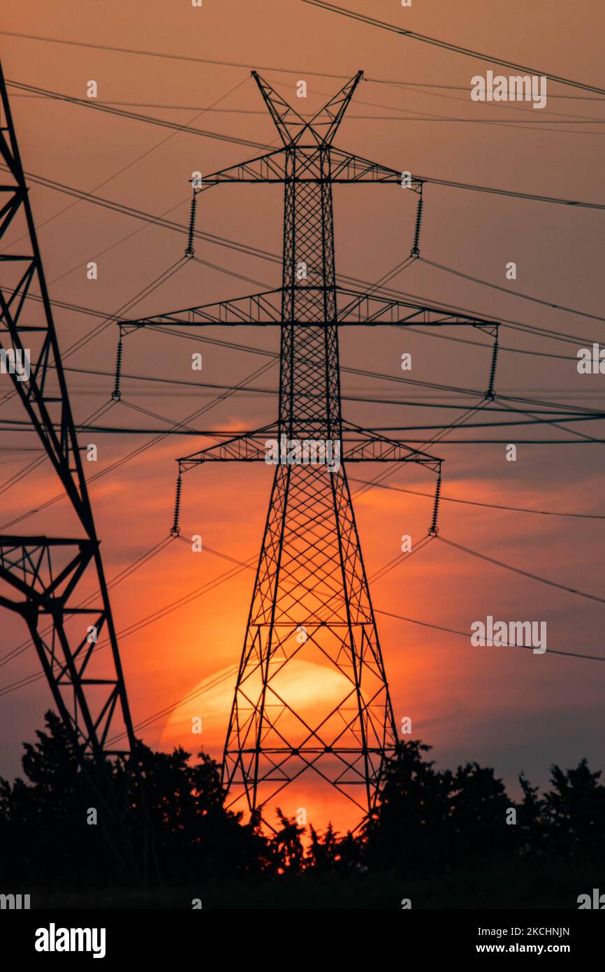Summer sunset in Greece with electrical pylons near Thessaloniki city