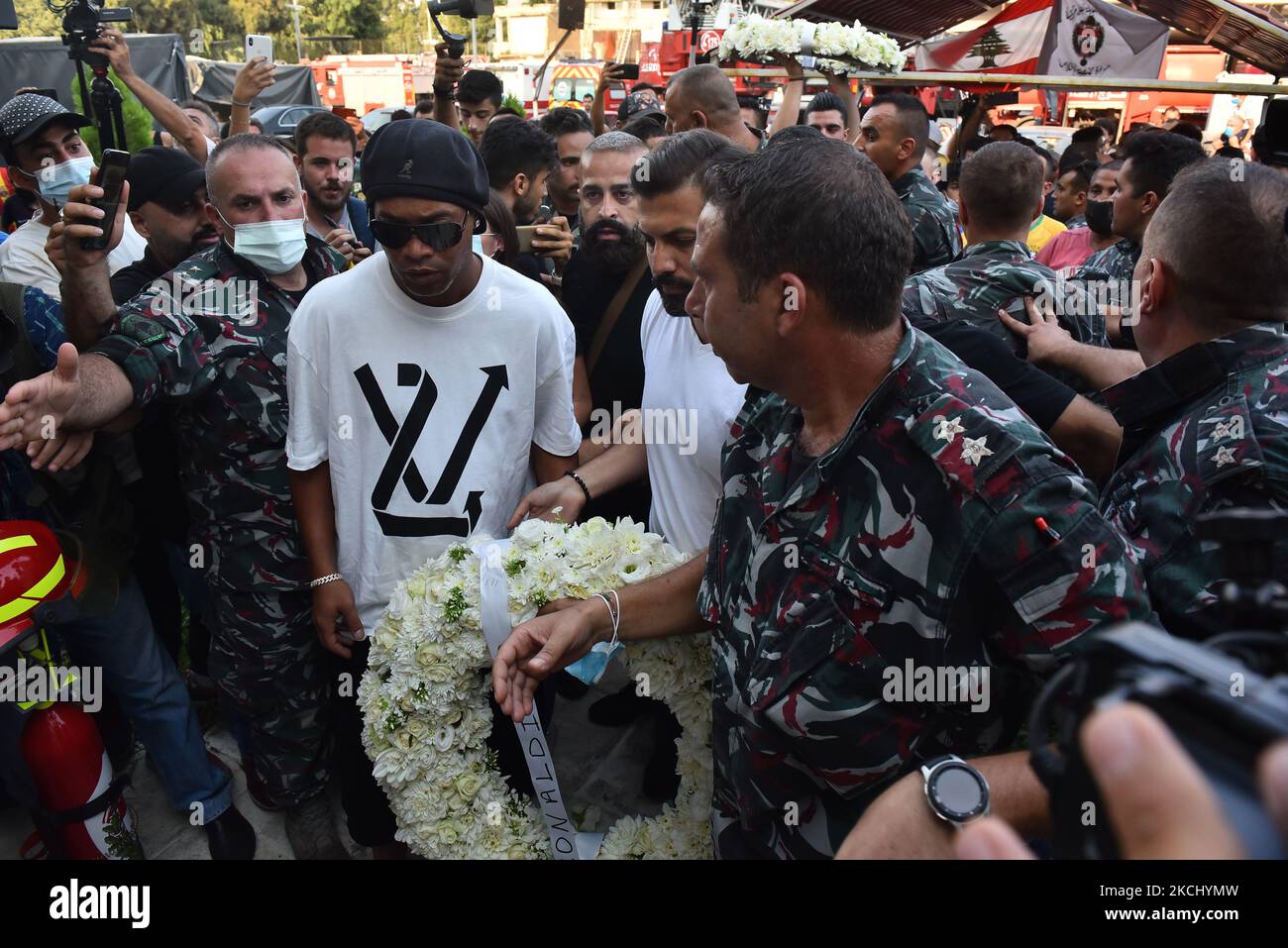 Brazil's former football star Ronaldinho arrives to lay a wreath of flowers in remembrance of members of the Lebanese civil defence that were killed almost a year prior during the blast that rocked the port of Lebanon's capital Beirut, at the Beirut fire brigade headquarters near the port blast site on July 29, 2021. (Photo by STR/NurPhoto) Stock Photo