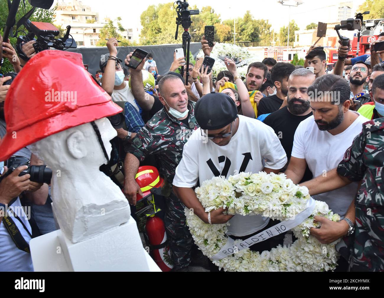 Brazil's former football star Ronaldinho arrives to lay a wreath of flowers in remembrance of members of the Lebanese civil defence that were killed almost a year prior during the blast that rocked the port of Lebanon's capital Beirut, at the Beirut fire brigade headquarters near the port blast site on July 29, 2021. (Photo by STR/NurPhoto) Stock Photo