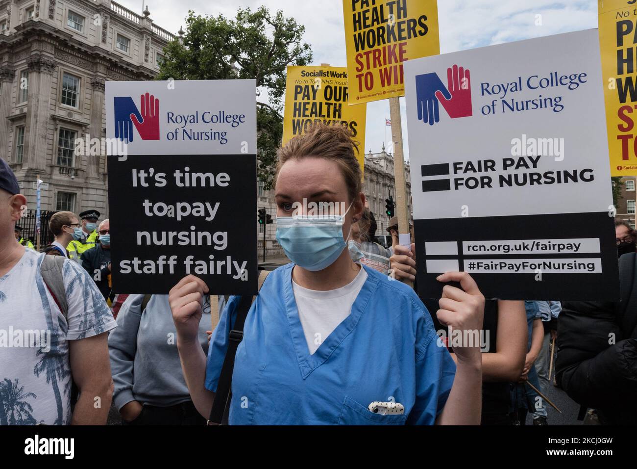 LONDON, UNITED KINGDOM - JULY 30, 2021: NHS staff and their supporters gather outside Downing Street during a protest demanding a fair pay increase for health workers on July 30, 2021 in London, England. The government has announced a 3% pay rise for the NHS staff in England and Wales following NHS Pay Review Body’s recommendations, however the campaigners argue the offer doesn't meet the inflation rate and undervalues healthcare workers who experienced unprecedented pressure during the coronavirus pandemic. (Photo by WIktor Szymanowicz/NurPhoto) Stock Photo