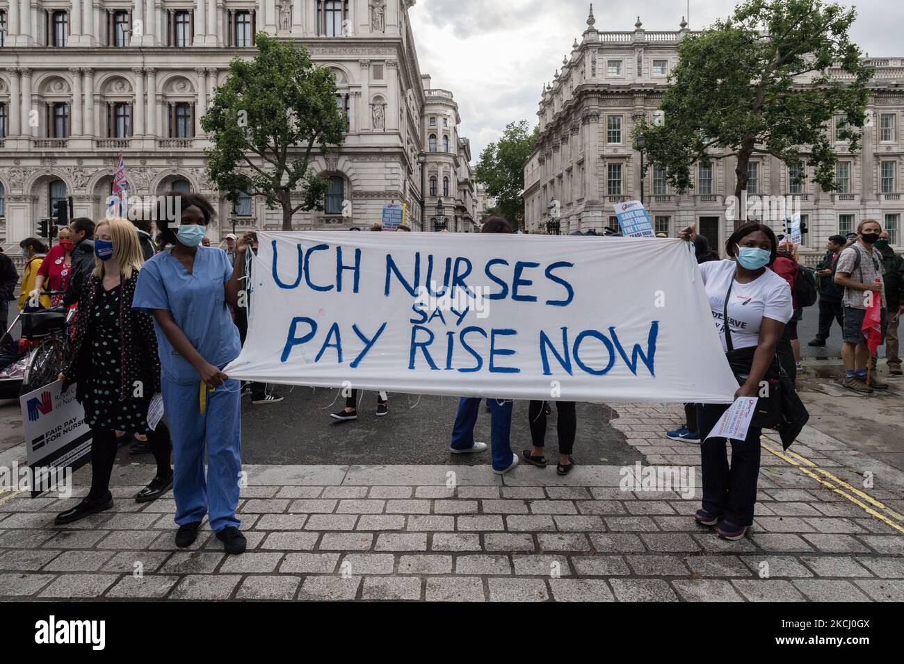 LONDON, UNITED KINGDOM - JULY 30, 2021: NHS staff and their supporters gather outside Downing Street during a protest demanding a fair pay increase for health workers on July 30, 2021 in London, England. The government has announced a 3% pay rise for the NHS staff in England and Wales following NHS Pay Review Body’s recommendations, however the campaigners argue the offer doesn't meet the inflation rate and undervalues healthcare workers who experienced unprecedented pressure during the coronavirus pandemic. (Photo by WIktor Szymanowicz/NurPhoto) Stock Photo