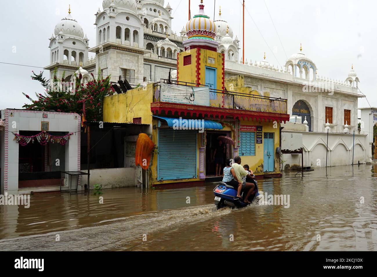 Indian People cross a Flooded street after heavy Monsoon Rains in ...