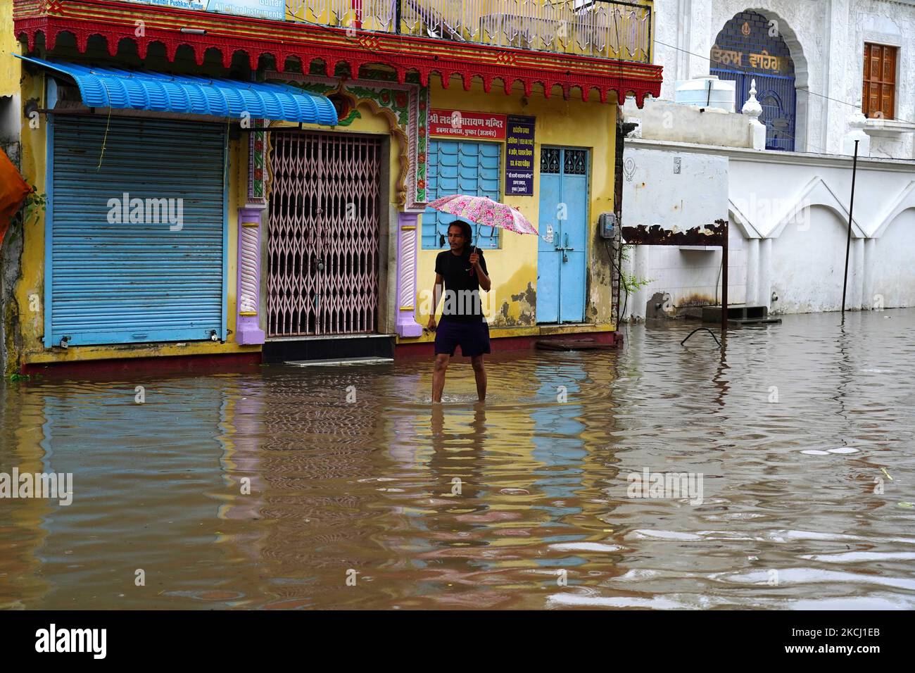 Indian People cross a Flooded street after heavy Monsoon Rains in ...