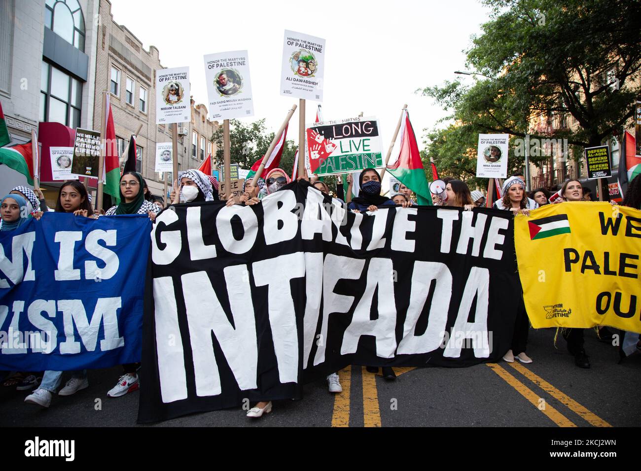 A sign reading ''Globalize The Intifada'' is seen on the ground as people demonstrate in support of Palestine in Brooklyn, New York, US, on July 31, 2021. (Photo by Karla Ann Cote/NurPhoto) Stock Photo