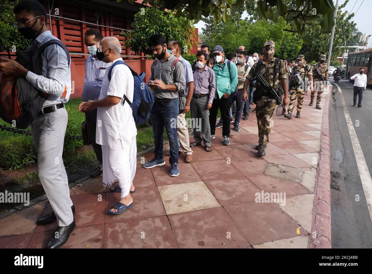 People stand in a long queue to enter Udyog Bhawan Metro station during rush hour amid the coronavirus pandemic (Covid-19), in New Delhi, India on August 2, 2021. (Photo by Mayank Makhija/NurPhoto) Stock Photo