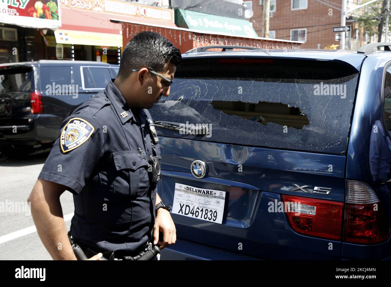 NYPD officers and detectives investigate a bullet riddled car following a recent mass shooting as mayoral candidate Curtis Sliwa blames the current administration for the lack of action in combatting gang shootings as they relate to illegal immigration during a press conference on August 2, 2021 in the Corona section of Queens a borough of New York City, USA. Sliwa discussed the importance of reinstating the recently dismantled NYPD gang unit and to increase cooperation among various federal agencies and the New York City Police Department. Other issues include keeping gang member database int Stock Photo