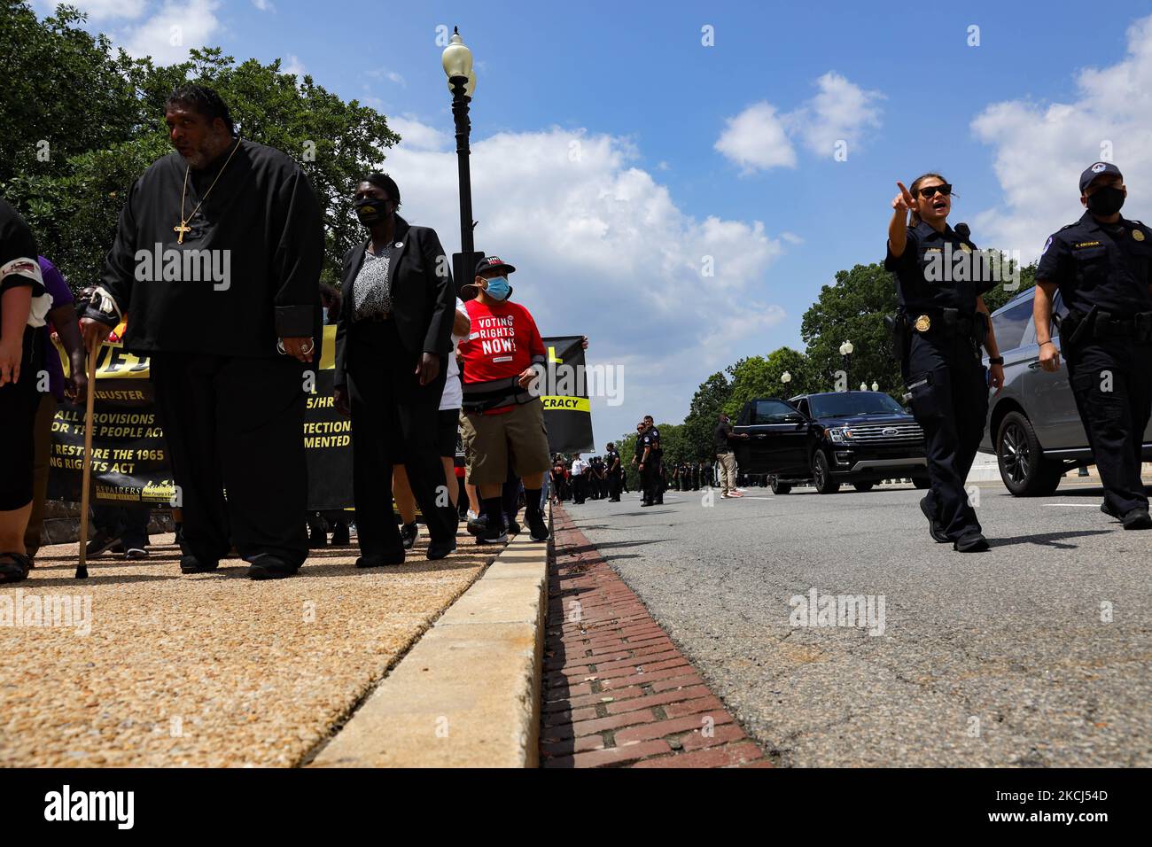 Reverend William Barber II marches in the Poor People's Campaign Moral Monday demonstration and civil disobedience action near the U.S. Capitol as Capitol Police officers direct people out of the roadway on August 2, 2021 (Photo by Bryan Olin Dozier/NurPhoto) Stock Photo
