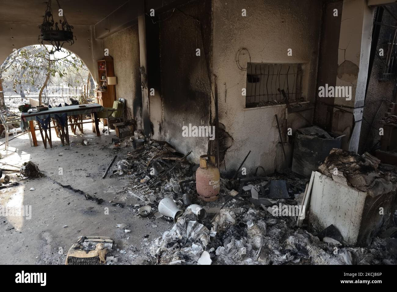 A house is destroyed by the wildfire in the northern suburb of Athens ...
