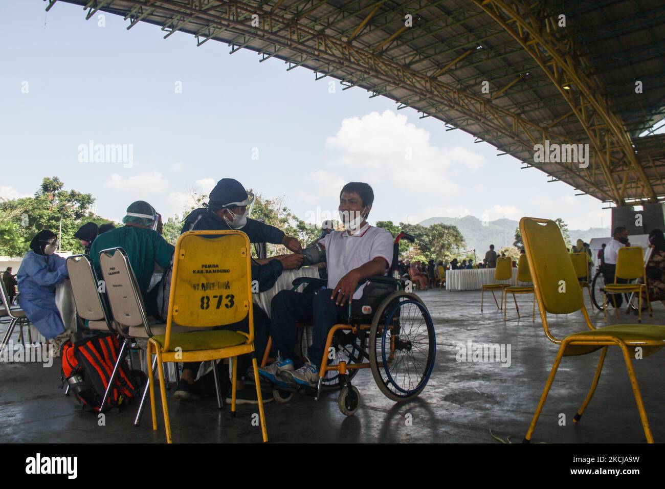 Medical officers check the health conditions of people with disabilities in Bale Rame, Bandung Regency on August 7, 2021. The Unpad Alumni Association provides 130 doses of vaccine for people with disabilities to accelerate national vaccination and facilitate athletes with disabilities to compete in the PERPARNAS XVI event. (Photo by Algi Febri Sugita/NurPhoto) Stock Photo