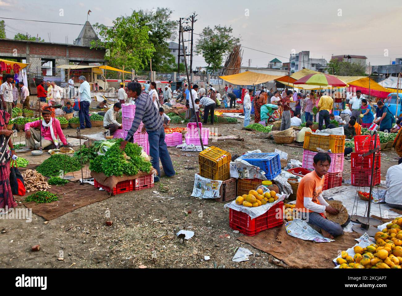Merchants sell vegetables at the Shaniwaar Subzi Bazaar, which is the