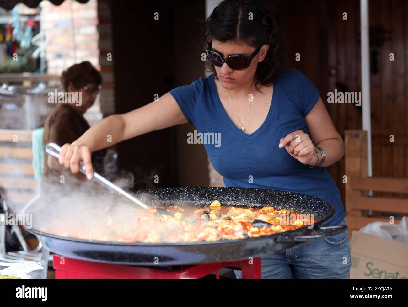 Woman stirring giant cooking pot hi-res stock photography and images - Alamy