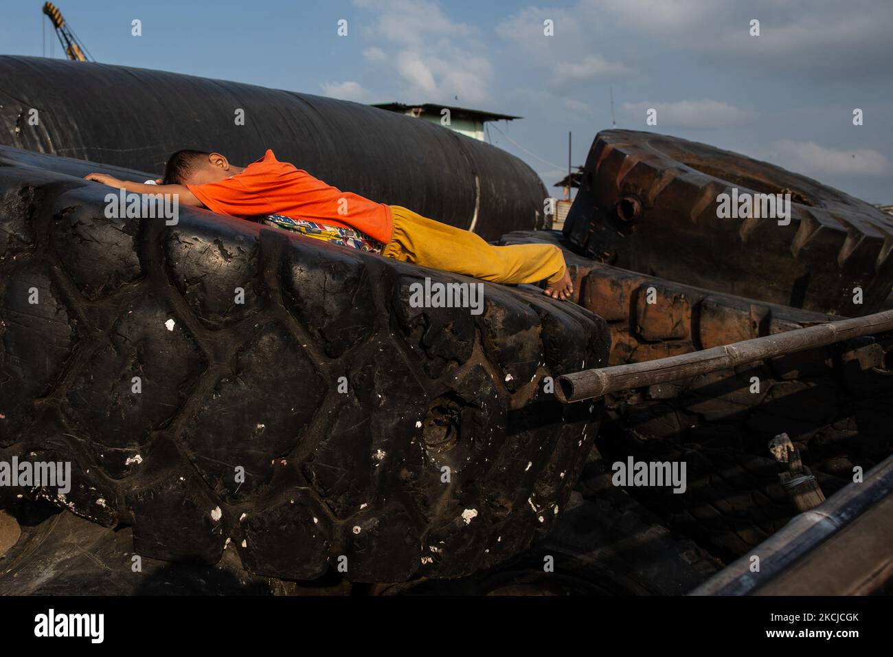 A child sleeps on tires of heavy equipment amid the spread of the coronavirus (COVID-19) outbreak at a slum area in Jakarta on 8 August 2021. UNICEF and the Fiscal Policy Agency (BKF) said more children and adolescents have fallen into poverty than any other age group as a result of the COVID-19 pandemic. These findings are based on a joint study estimating the situation of child poverty during the pandemic. Children under the age of 18 represent about 33 per cent of Indonesia’s population, but nearly 40 per cent of the new people who fell under the poverty line in 2020 due to the pandemic. (P Stock Photo