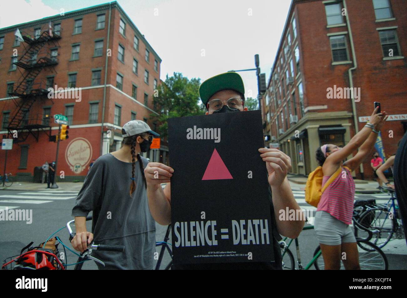 A protester holds a silence equals death sign in front of Mayor Jim Kenney’s condo during a housing protest, in Philadelphia, PA, on August 10, 2021. (Photo by Cory Clark/NurPhoto) Stock Photo