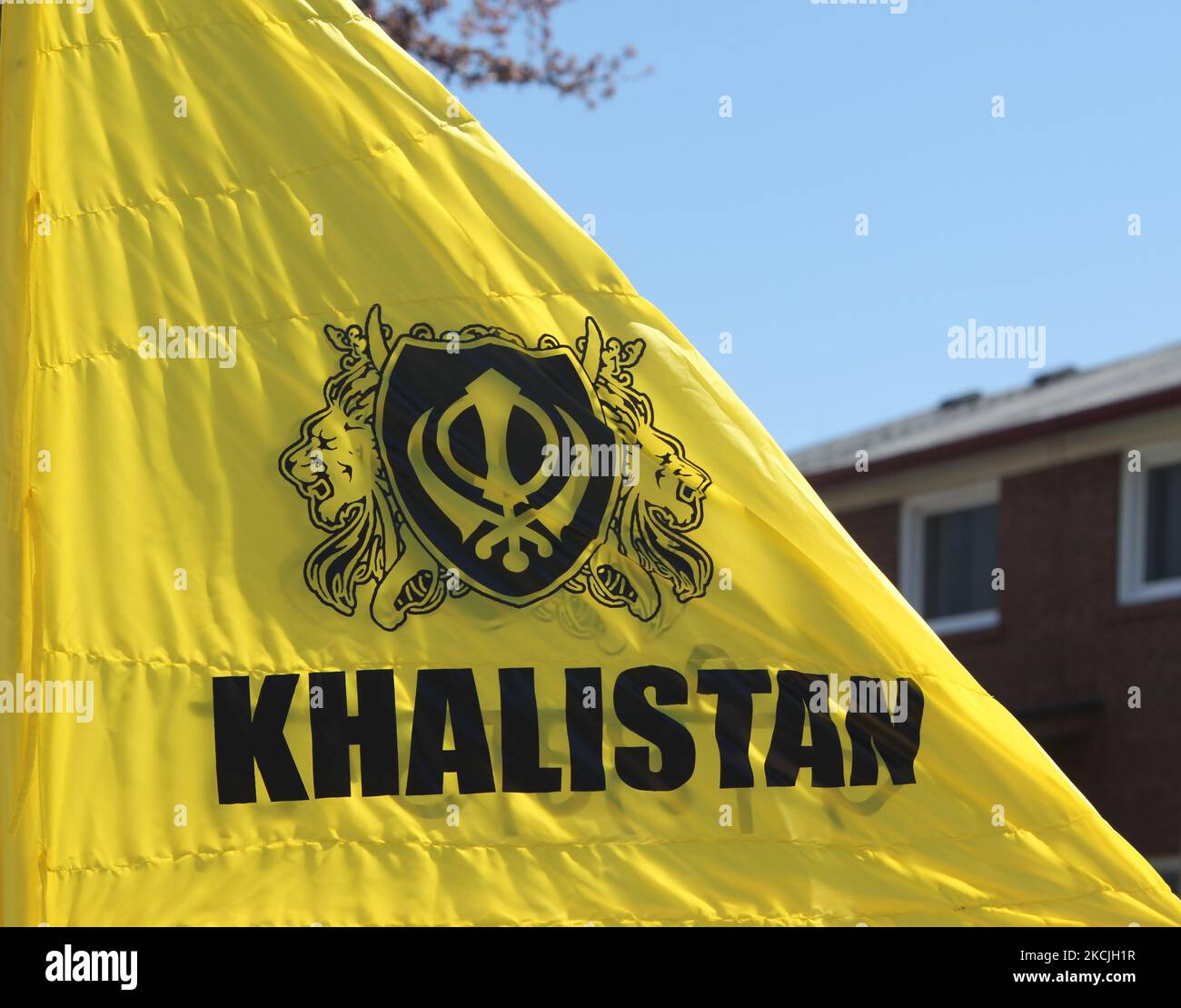 Khalistan flag seen as Canadian Pro-Khalistan Sikhs protest against the Indian government and call for a separate Sikh state called Khalistan in Malton, Ontario, Canada, on May 05, 2013. Thousands of Sikhs attended a Nagar Kirtan to celebrate Vaisakhi and to show their discontent with the Indian government. The Khalistan movement refers to a movement which seeks to create a separate Sikh state, called Khalistan in the Punjab region of India. The territorial definition of the proposed nation is disputed, with some believing it should be carved simply out of the Indian state of Punjab, where Sik Stock Photo