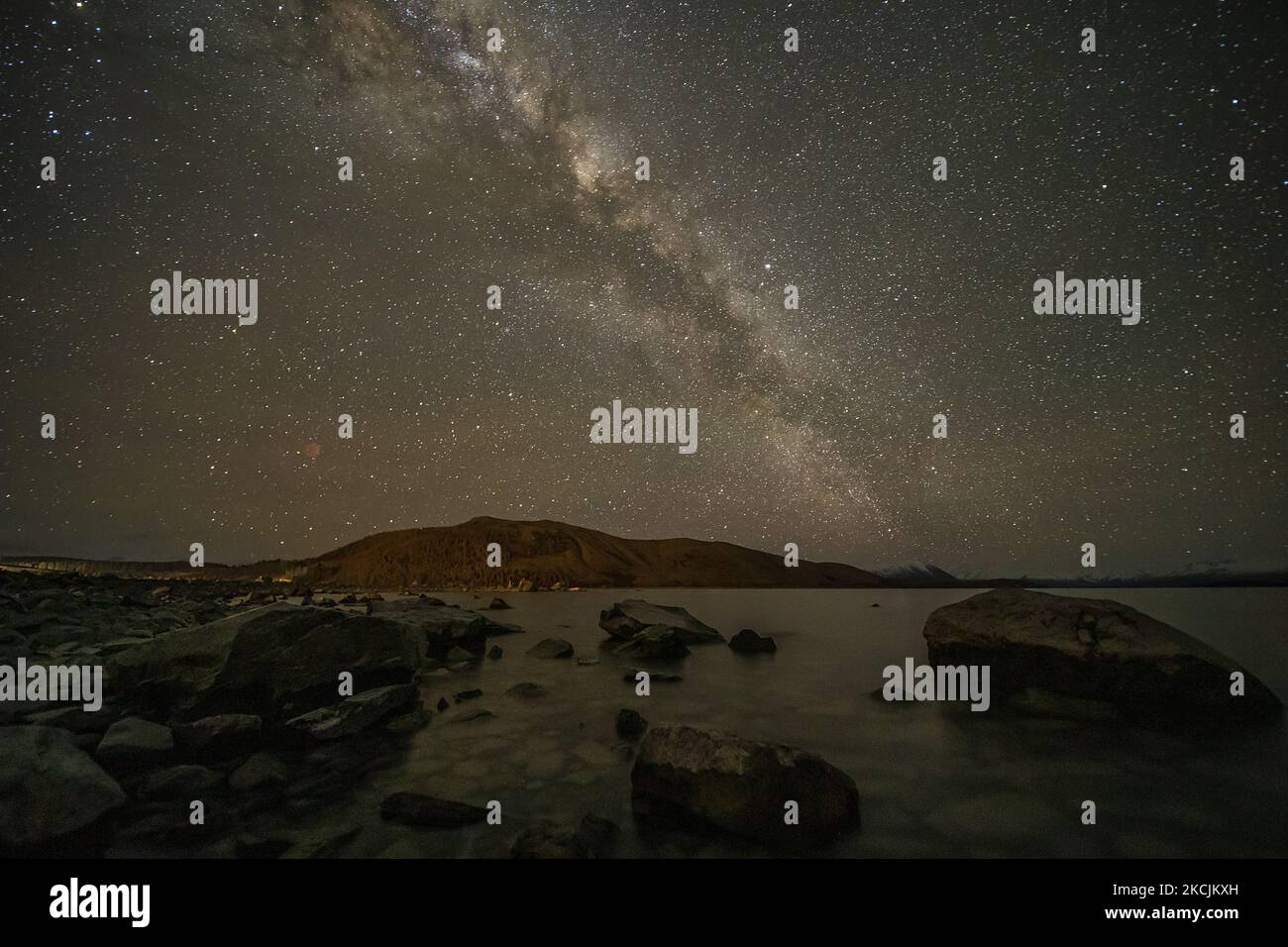 The Milky Way appears in the sky above the Lake Tekapo in the Mackenzie ...