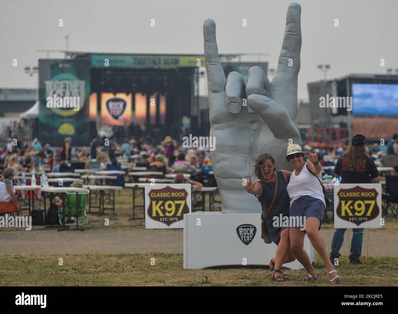 Two ladies posing for a photo at Edmonton Rock Fest, a part of the