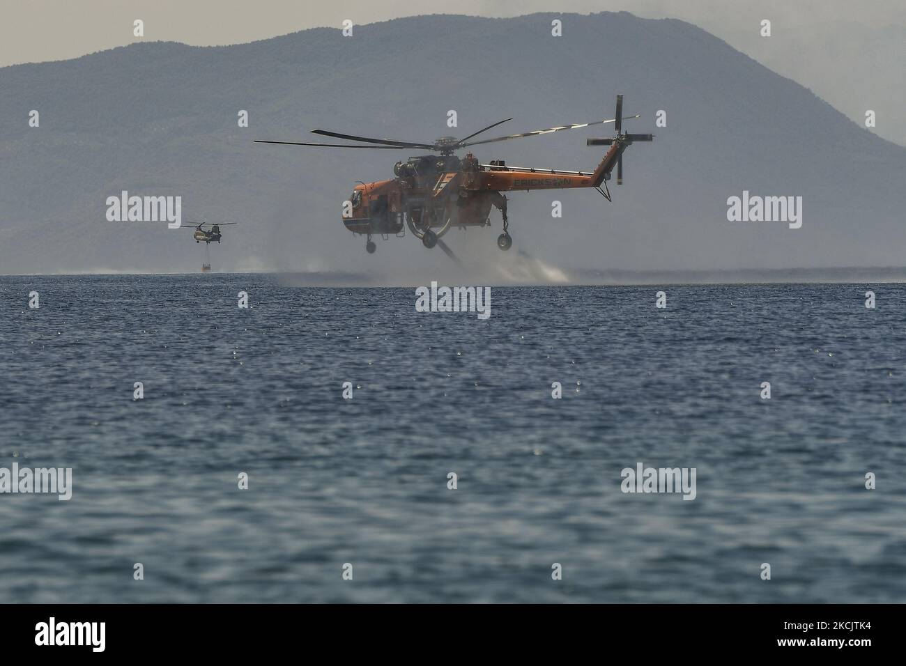 Firefighter helocopter revealed with water during a wildfire in the area of Villia north-western of Athens, Greece, 17 August 2021. (Photo by Dimitris Lampropoulos/NurPhoto) Stock Photo
