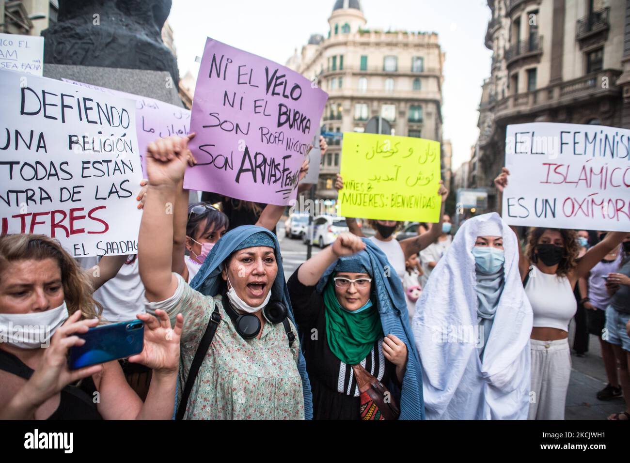 Protesters are seen with the burqa removed. Around a hundred women have participated in a feminist demonstration in front of the United Nations headquarters in Barcelona, Spain, on August 17, 2021 to demand an urgent international response to protect Afghan women and girls. (Photo by DAX Images/NurPhoto) Stock Photo