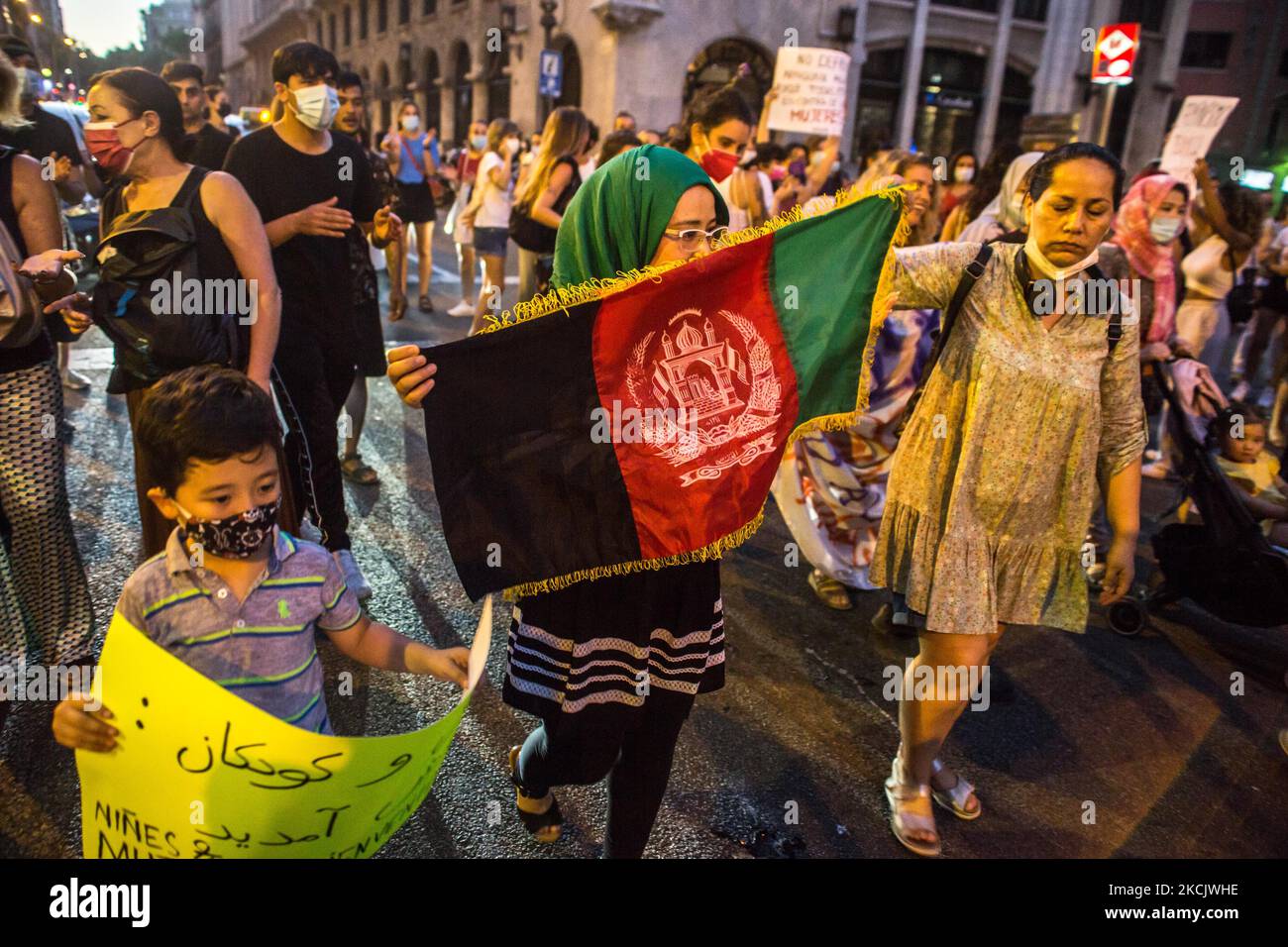 Protesters are seen with the flag of Afghanistan. Around a hundred women have participated in a feminist demonstration in front of the United Nations headquarters in Barcelona, Spain, on August 17, 2021 to demand an urgent international response to protect Afghan women and girls. (Photo by DAX Images/NurPhoto) Stock Photo