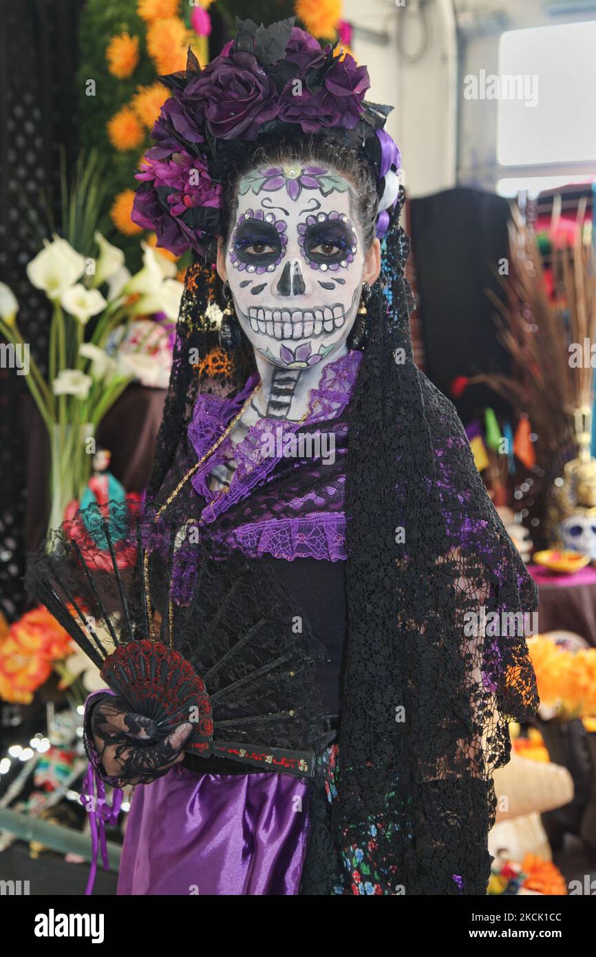 day of the dead purple dress Young woman dressed as 'La Catrina the Diva of Death' during celebrations  for the Day of the Dead (Dia de los Muertos) in Toronto, Ontario, Canada,  on November 07, 2015. The Day