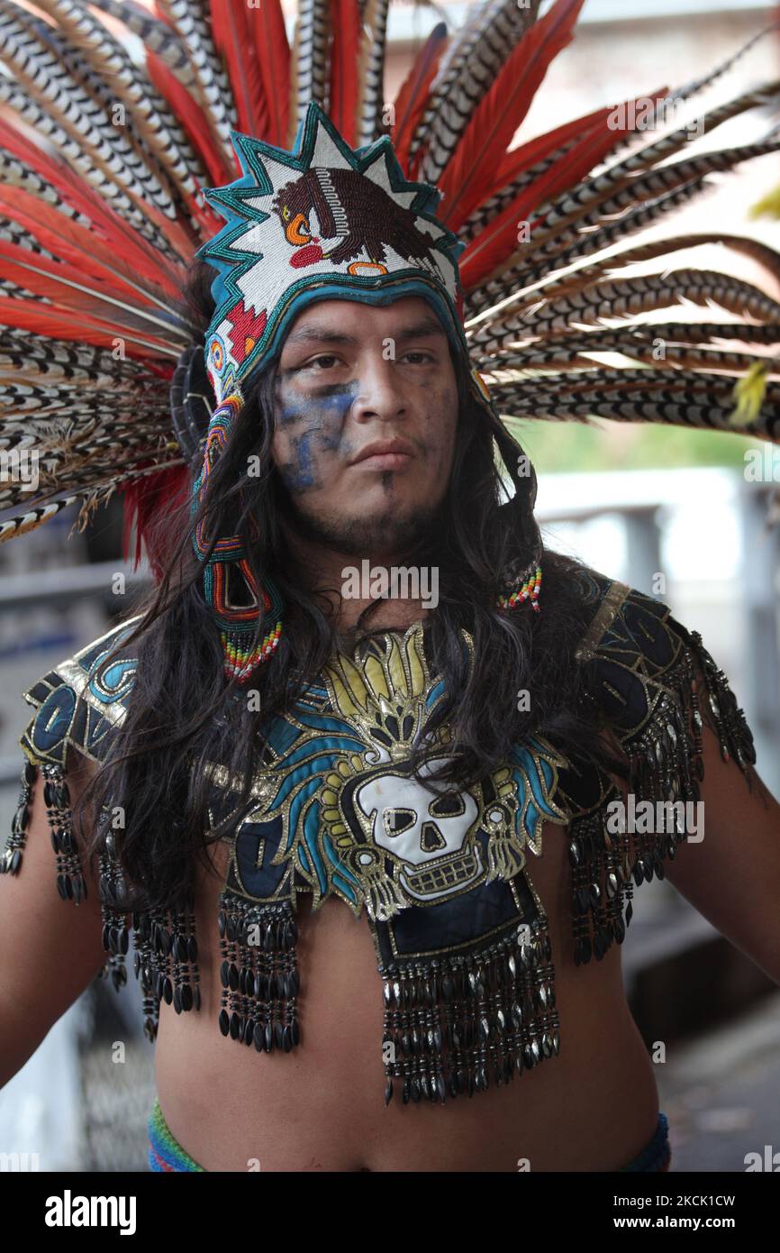 Mexican dancer dressed in an Aztec costume while performing a cultural ...