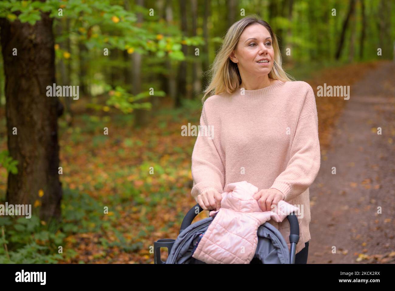 Woman walking in forest blond hair hi-res stock photography and images -  Alamy