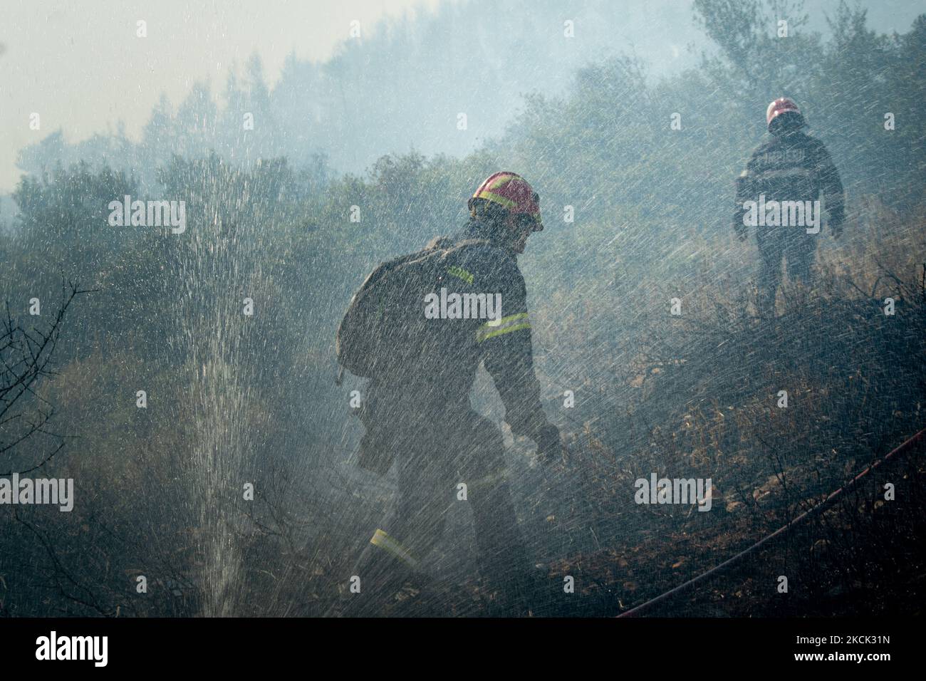 Firefighters trying to tame the flames at the Vilia wildfire. On August 23rd, in 2021 in Vilia, Attica (Athens), Greece. (Photo by Maria Chourdari/NurPhoto) Stock Photo