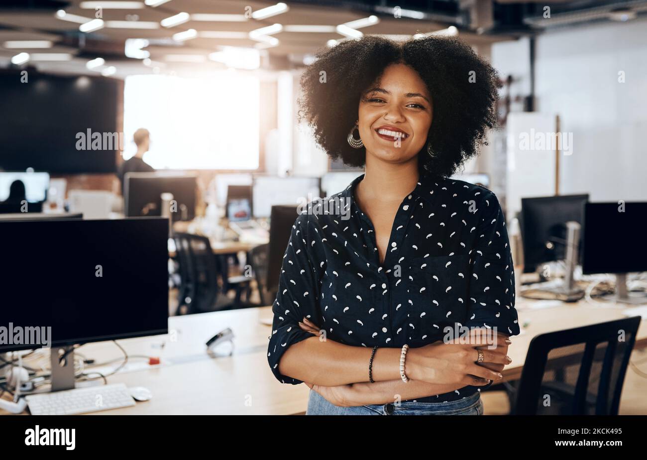 Positivity is my everyday mood at work. Portrait of an attractive young female designer smiling and in good spirits at the office. Stock Photo