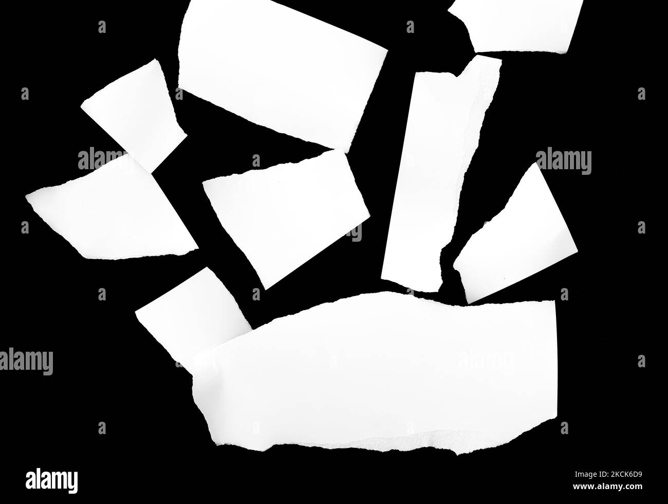 Various sized white scrap paper on black background Stock Photo Alamy