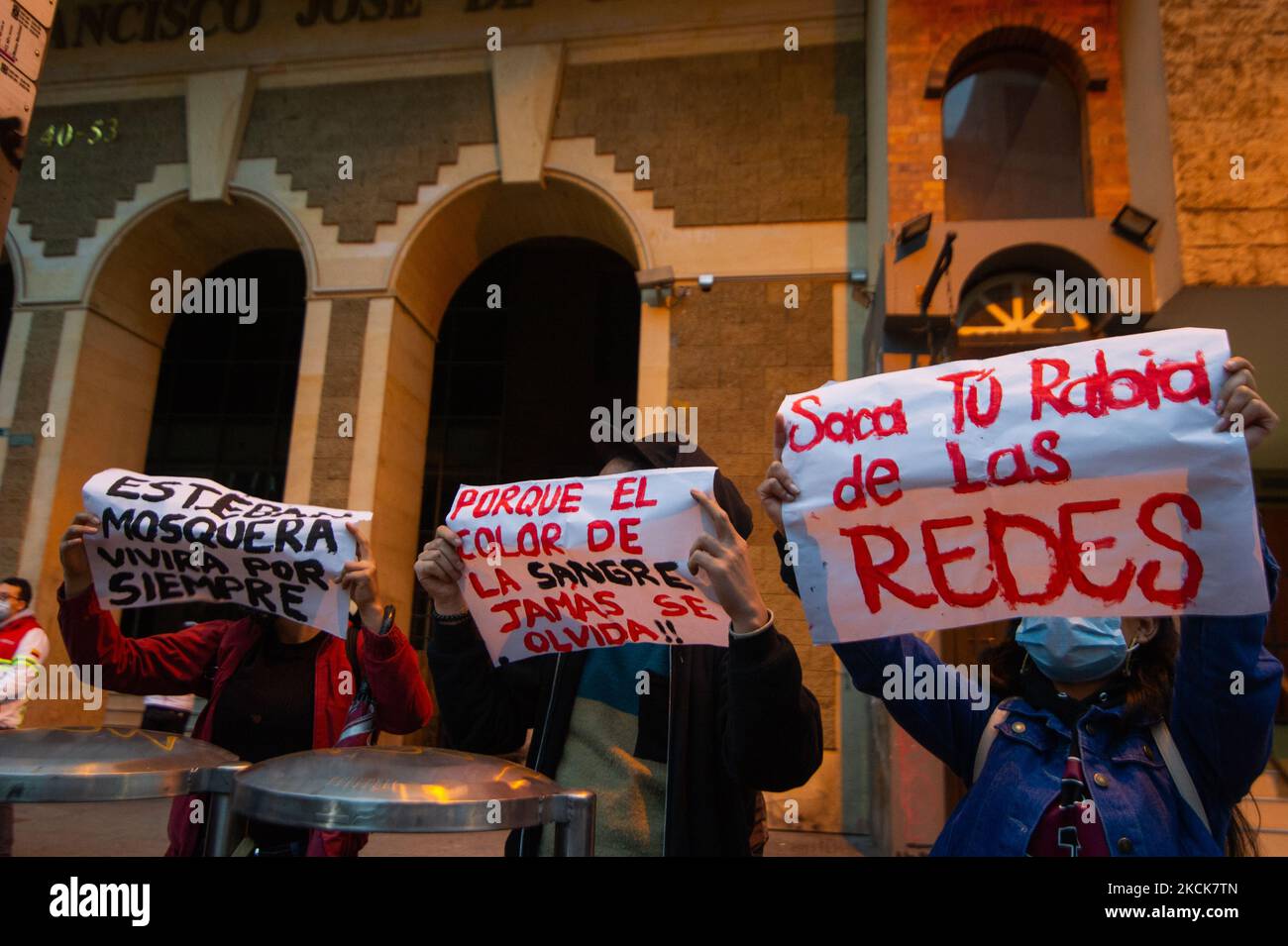 Demonstrators hold signs against police brutality during a student rally of the Universidad Distrital, after Esteban Mosquera, a social leader and community member was killed two years after loosing his eye on a police brutality case, in Bogota, Colombia on August 26, 2021. (Photo by Sebastian Barros/NurPhoto) Stock Photo