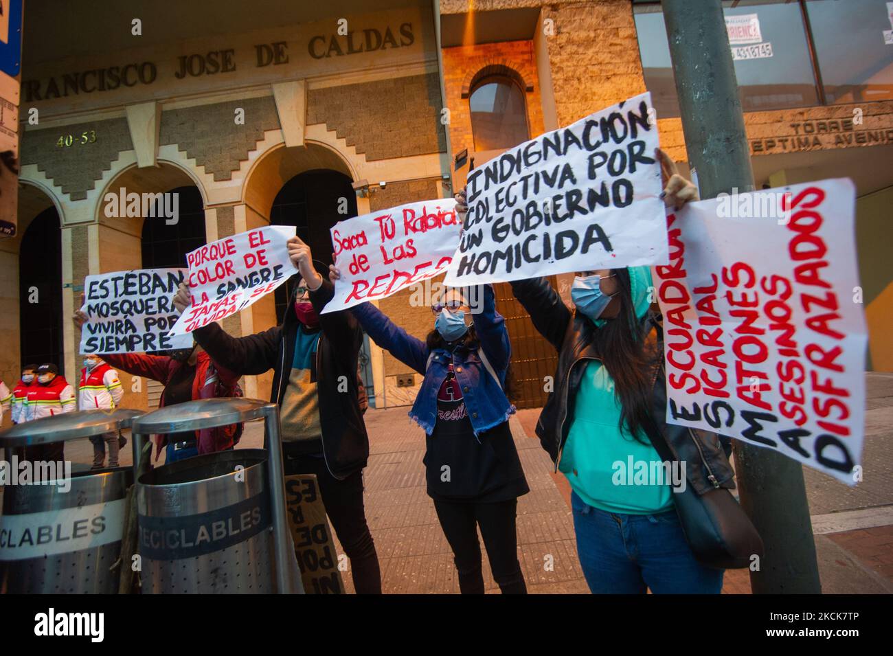 Demonstrators hold signs against police brutality during a student rally of the Universidad Distrital, after Esteban Mosquera, a social leader and community member was killed two years after loosing his eye on a police brutality case, in Bogota, Colombia on August 26, 2021. (Photo by Sebastian Barros/NurPhoto) Stock Photo