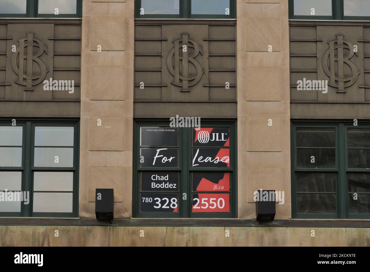 A 'For Lease' sign visible in the windows of an office building in