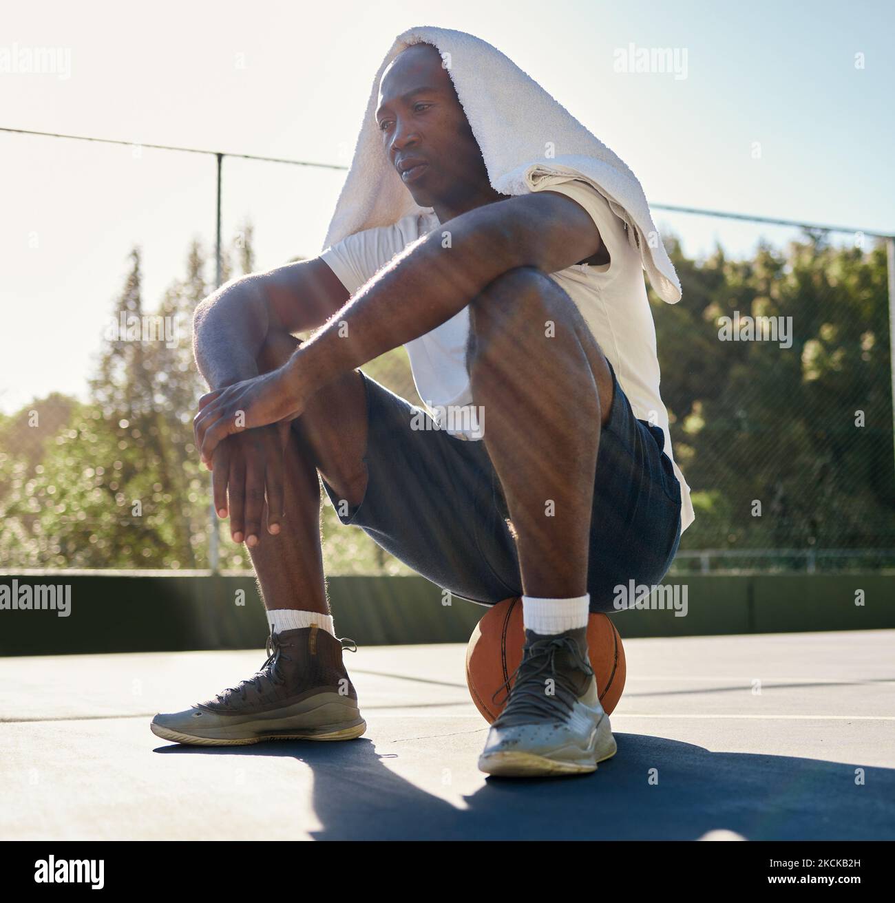 Basketball, fitness and a tired black man in sports sitting on a ball