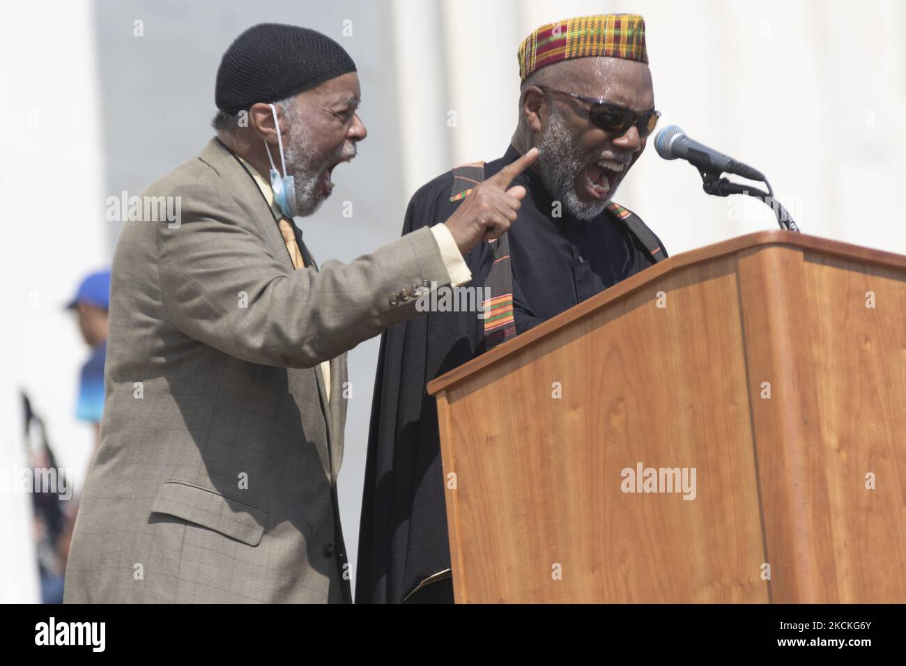 Imam Johari Abdul Malik, right, delivers a invocation before the