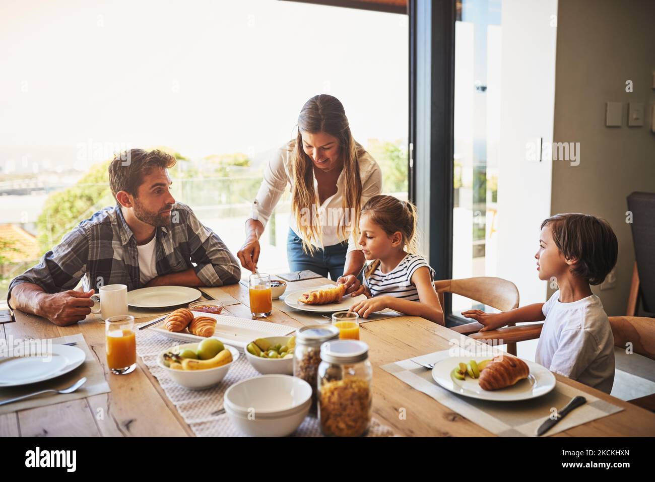 Starting their day together. a family having breakfast together at home. Stock Photo