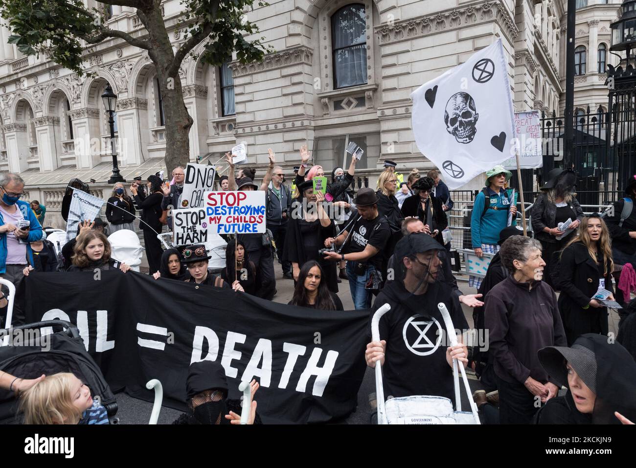 LONDON, UNITED KINGDOM - AUGUST 31, 2021: Activists from Extinction Rebellion block the entrance to Downing Street during a funeral march demanding an immediate stop to all fossil fuel investment by the British government amid climate crisis and ecological emergency on 31 August 2021 in London, England. The action is a part of the 'Impossible Rebellion', a new wave of protests and civil disobedience actions targeting government and financial institutions. (Photo by WIktor Szymanowicz/NurPhoto) Stock Photo