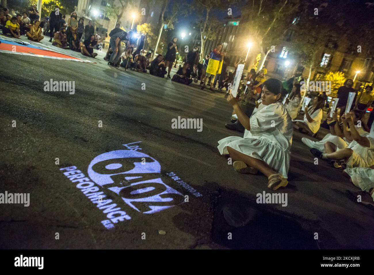 Protesters are seen in front of projection with which says, the 6402 ...