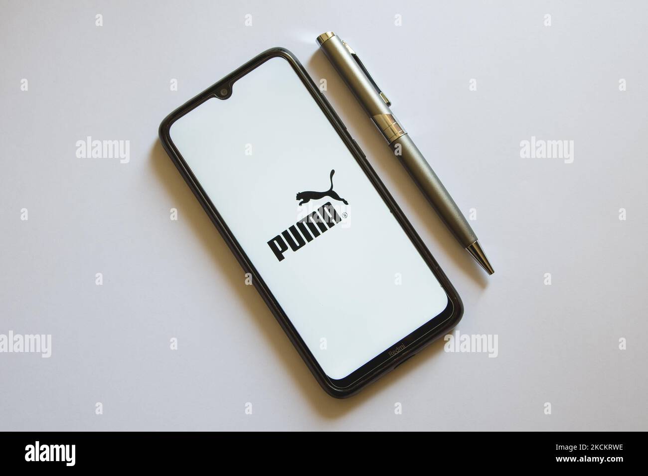 In this photo illustration a Puma logo is display on a smartphone screen and a pencil in Athens, Greece on September 3, 2021. (Photo by Nikolas Kokovlis/NurPhoto) Stock Photo